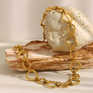 Close-up of 18K gold-plated chunky chain necklace on natural stone display