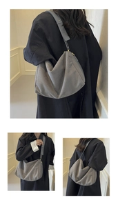 Detail view of grey suede hobo bag with leather shoulder strap and gold hardware