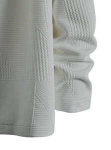 Close-up of white 3D geometric relief fabric with intricate jacquard weave texture