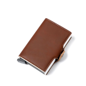 Close-up of brown PU leather and aluminum twin-case wallet with pop-up card mechanism
