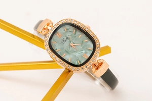 Close-up of Tadi ladies' watch with gold rhinestone bezel and green textured dial
