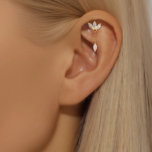 Detail of S925 silver ear cuff featuring marquise zircon flower and long gold tassel chain