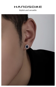 Close-up of blue crystal cluster stud earring with white stones on male model's ear