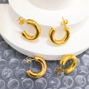 Polished 18k gold C-shaped hoop earrings with minimalist thick tubular design