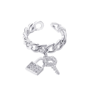Detailed close-up of silver Cuban link ring featuring pavé crystal lock and key charms