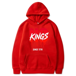 Detail of red hoodie showing the NO KINGS SINCE 1776 printed graphic and drawstring hood