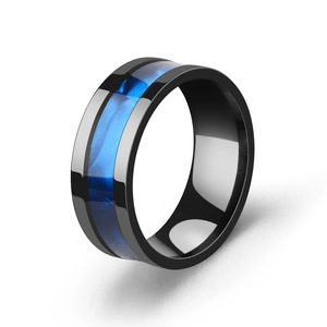 Detail of black stainless steel ring featuring an inlaid shimmering blue shell pattern
