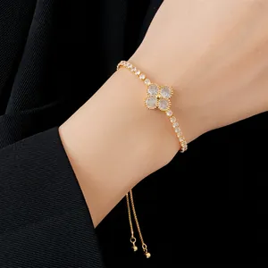 Gold-plated adjustable clover bracelet with sparkling cubic zirconia on female wrist