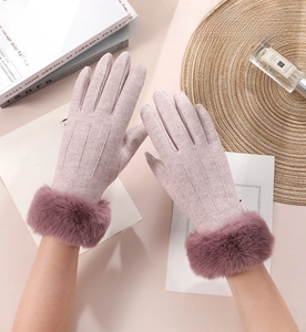 Detail of warm winter gloves for women featuring plush fur trim and velvet lining