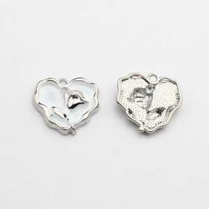 Front and back detail of silver heart charm with white rose enamel design for DIY jewelry