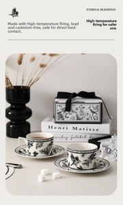 Detail of vintage floral ceramic coffee cup set with black botanical illustrations and gift box