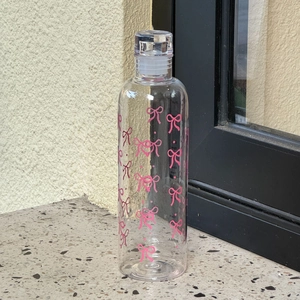 Detail view of 400ml plastic water bottle with pink bow patterns and capacity scales