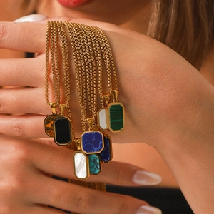 Gold stainless steel necklaces with various rectangular natural stone pendants on a model
