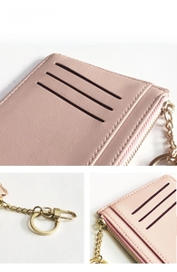 Detailed view of pink leather card holder with three card slots and gold zipper hardware