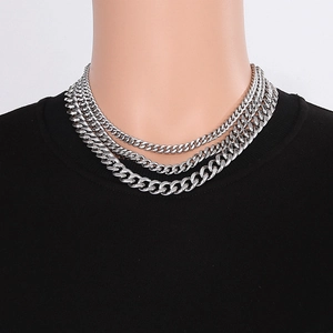 Three-layer silver stainless steel Cuban link necklace worn by a model for a hip-hop look