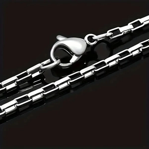 Polished silver stainless steel box chain necklace with lobster clasp on black background