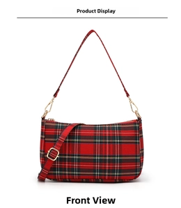 Front detail of red plaid baguette bag with vintage gold hardware and adjustable strap