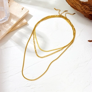 Three-layer gold stainless steel necklace featuring snake and figaro chain layers