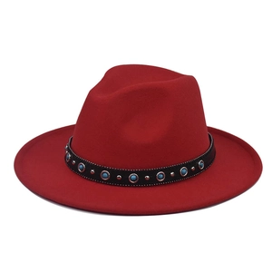 Detail of red wool felt fedora featuring black band with turquoise beads and silver studs