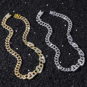 Gold and silver iced out Cuban necklaces with heart-shaped links and diamond accents
