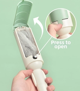 Detail of the push-to-open hair collection compartment showing pet fur removal effect