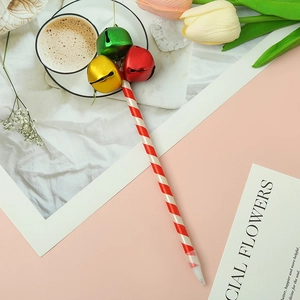Detail of creative Christmas ballpoint pens with red and white stripes and colorful metal bells