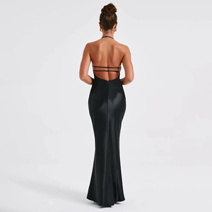 Detail of elegant black backless dress with halter neck and silky satin texture