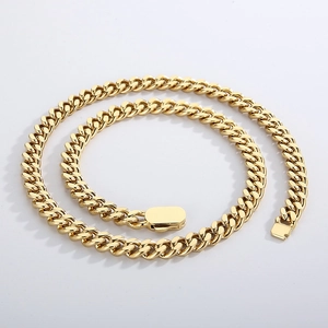 Detail of high-polished gold Cuban link necklace with secure snap clasp closure