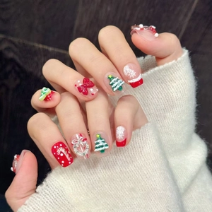 Christmas reindeer press-on nails with 3D tree, red bows and festive holiday nail art
