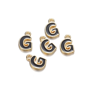 Detailed view of five gold-plated enamel letter G charms for DIY jewelry making
