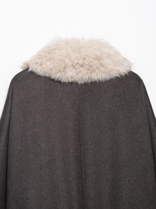 Close-up of beige faux fur collar on dark grey jacket back view on white background