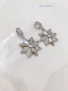 Macro detail of silver octagonal star pendants with sparkling pavé cubic zirconia