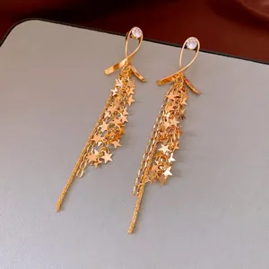 Elegant gold star tassel drop earrings featuring cubic zirconia and delicate chain fringe