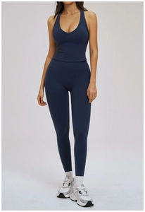 Detail of navy blue high-waist yoga set featuring a racerback tank top and leggings