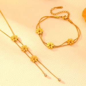 Detailed view of dual-layer gold-plated snake chains with elegant flower pendants