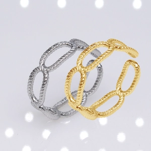 Close-up of gold and silver chain texture stainless steel rings on a white background