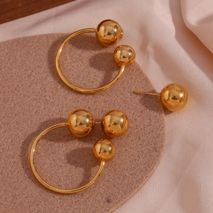 Detailed view of 18K gold-plated large hoop earrings featuring three sphere geometric design