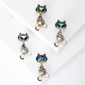 Elegant cat brooch set with crystals in four colors on white geometric platforms