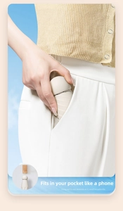 Close-up of compact capsule umbrella fitting into a pocket showing ultra-small size