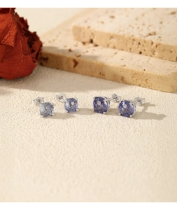 Detail of S925 sterling silver stud earrings with sparkling tanzanite-colored stones