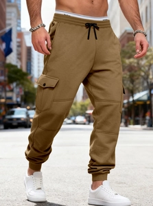 Outdoor street view of heavy cotton cargo joggers with drawstring waist and deep side pockets