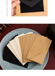 Close-up of vintage mini kraft paper envelopes in black, beige, and brown colors