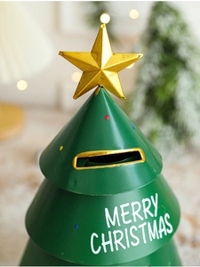 Detail of dark green metal Christmas tree piggy bank with gold star and Merry Christmas text