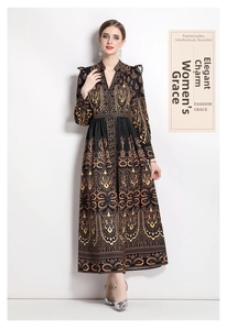 Detail of V-neck long sleeve paisley dress with golden patterns on black fabric