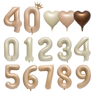 Detail of 40-inch cream and caramel numbered balloons set with heart shaped accents