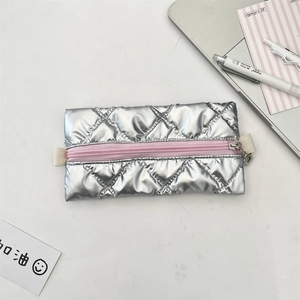 Detailed view of silver quilted pencil case with pink zipper and chic metallic finish
