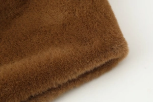 Close-up of the thick, fluffy dark brown faux fur texture with dense fibers and soft sheen