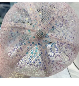 Detailed view of pink lace baseball cap with sparkling colorful sequins and mesh texture