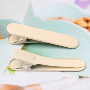 Close-up of beige matte duckbill hair clips showing front and back metal structures