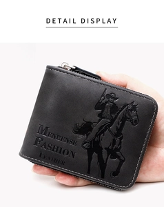 Close-up of black leather wallet featuring a detailed western cowboy embossed pattern